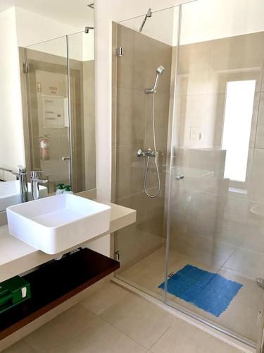 a white bathroom with a sink and a shower at NEW STUNNING OCEAN APRT IN "OASIS MAR" Wi-Fi in Portimão