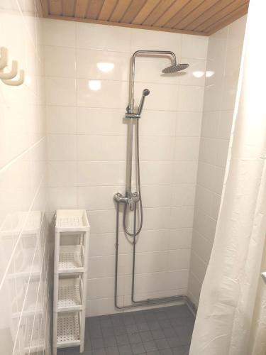 a bathroom with a shower with a shower curtain at Reipas in Kotka