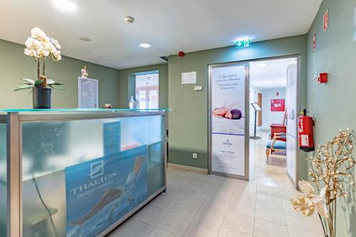 a hospital room with a reception counter and a door at Boa Vista Hotel & Spa - Adults Only in Albufeira