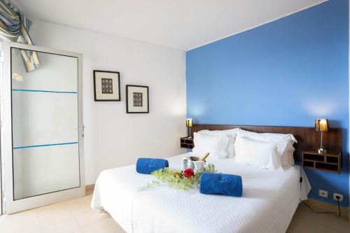 a bedroom with a large white bed with flowers on it at Boa Vista Hotel & Spa - Adults Only in Albufeira