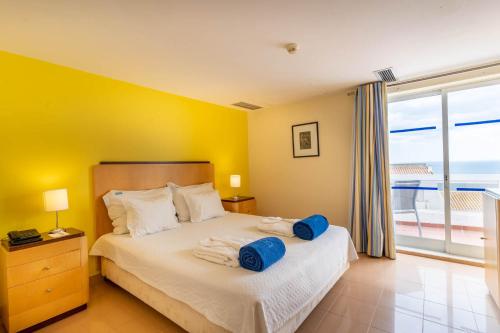 a bedroom with a bed with blue towels on it at Boa Vista Hotel & Spa - Adults Only in Albufeira