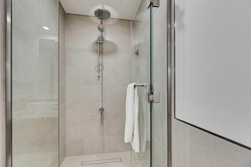 a shower with a glass door in a bathroom at Luxury 1BD apartment in Madinat Jumeirah Living in Dubai