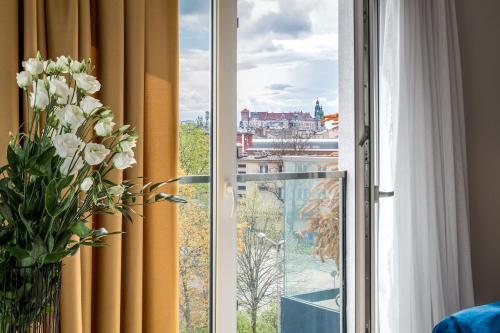 a window with a view of a city at InPoint Apartments G13 near Old Town & Kazimierz in Krakow