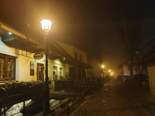a street light on a foggy street at night at Apartamenty Magiczna Wenecja in Cieszyn