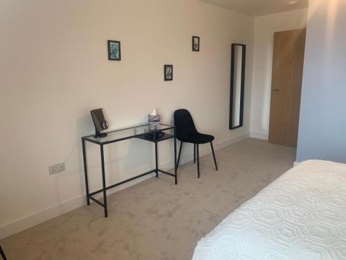 a bedroom with a desk and a chair next to a bed at The Retreat in Weston-super-Mare
