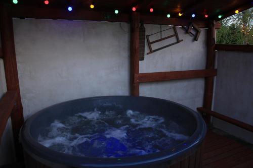 a large blue hot tub in a patio with lights at Wolna Chwila in Maków
