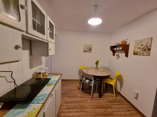 a kitchen with a table and a small dining room at Wolna Chwila in Maków