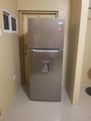 a refrigerator in the corner of a room at Marshan villa in Montego Bay