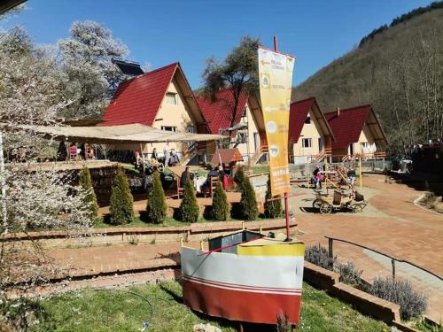 a boat sitting on the grass in front of a house at Etno selo "Vile Jefimija" in Vranje