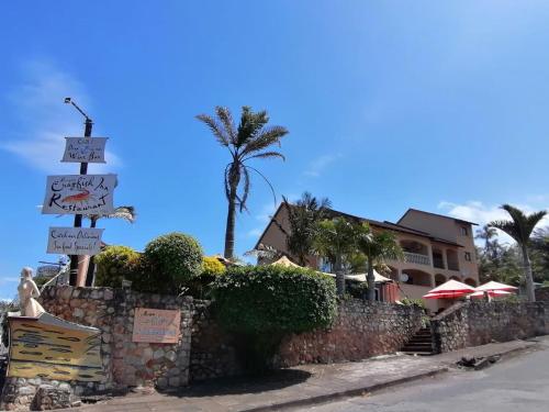 a street sign in front of a building with a palm tree at Crayfish Inn no5 in Ramsgate