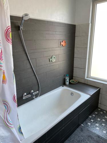 a bath tub in a bathroom with a shower at City room in Alkmaar