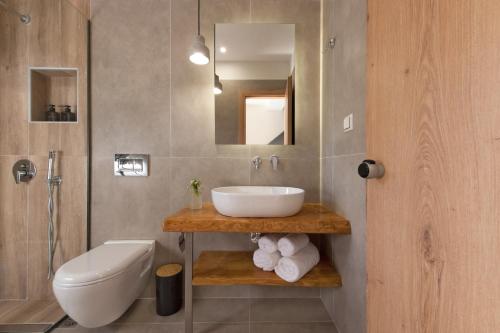 a bathroom with a sink and a toilet at Del Mare Suites in Glífa