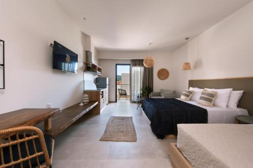 a bedroom with a bed and a table in a room at Del Mare Suites in Glífa