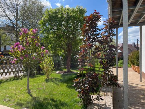 a garden with trees and flowers in a yard at Villa Florentine in Bad Liebenstein