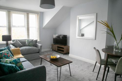 a living room with a couch and a table at Harlow Apartment 3 in Harrogate