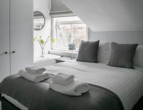 a bedroom with a bed with towels on it at Harlow Apartment 3 in Harrogate