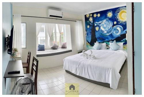 - une chambre avec un lit et une peinture murale dans l'établissement Hooman Hostel, à Chiang Mai