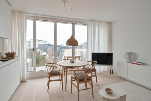 a kitchen and dining room with a table and chairs at Inselhouse in Norderney
