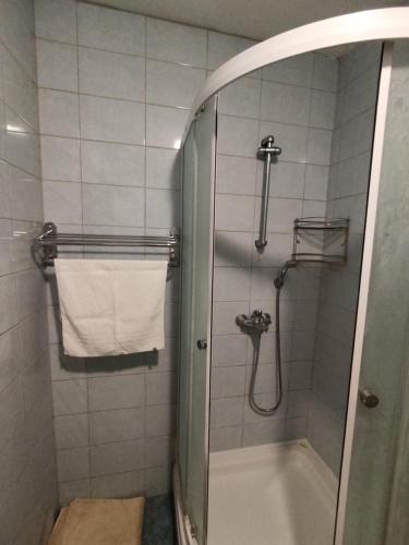 a bathroom with a shower with a tub and a towel at Apartment Angela in Dubrovnik
