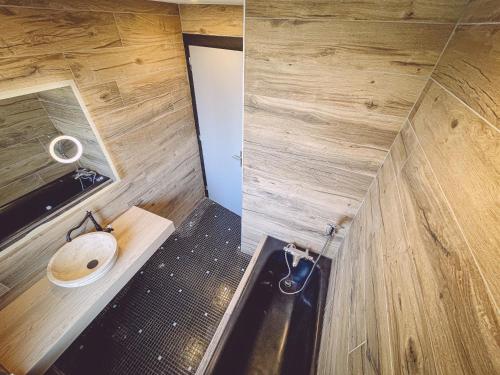 a small bathroom with a toilet and a sink at Kombi By Carl-Emilie in Épinal