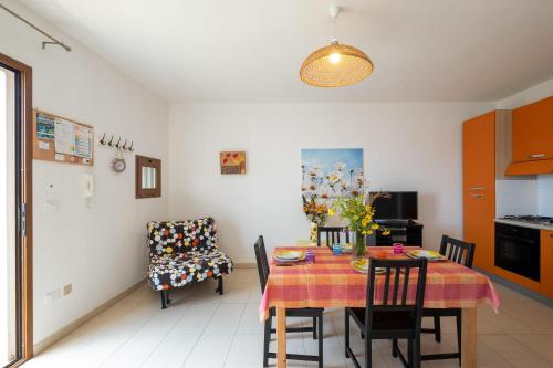 a kitchen and dining room with a table and chairs at Staiulo - Primo Piano - La Plumeria in Leuca