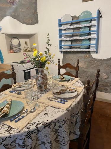 a dining room table with a blue and white table cloth at Patmos Horizon in Patmos