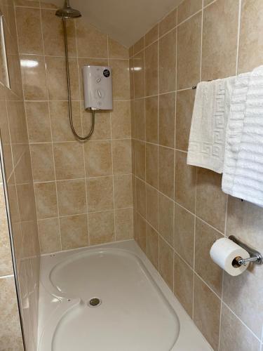 a bathroom with a shower with a tub and a toilet at Arkleside Country Guest House in Reeth