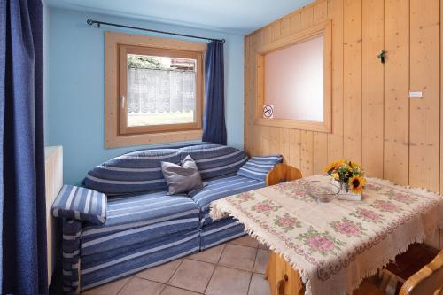 a living room with a blue couch and a table at Orsa Maggiore in Livigno