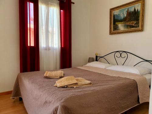 a bedroom with a bed with two towels on it at THE MANSION OF DIONISOS AND DIMITRAS 2 in Olympia