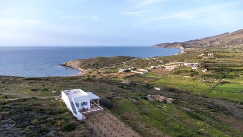an aerial view of a house on a hill next to the ocean at Kalliston Naxos in Akrotiri