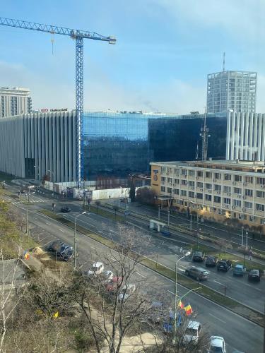 a view of a city with a crane and buildings at Take PRO Timisoara Apartment in Timişoara