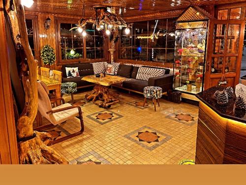 a living room with a couch and a table at Ayder Avusor Hotel in Ayder Yaylasi