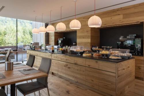 a restaurant with a counter with food on it at Residence Adamello Resort in Ponte di Legno