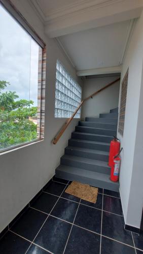 a staircase in a building with a window at Flats Atitude Maragogi centro in Maragogi
