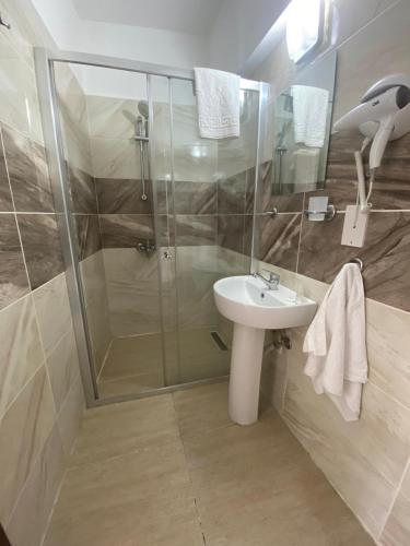 a bathroom with a shower and a sink at En Kaya Hotel in North Nicosia