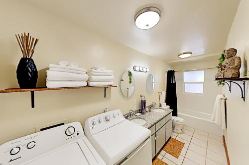 a bathroom with a sink and a washing machine at Genoa Haven in South Lake Tahoe