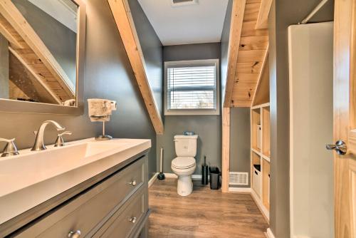 a bathroom with a toilet and a sink at Lakefront Lexington Escape: Steps to Beach! in Lexington