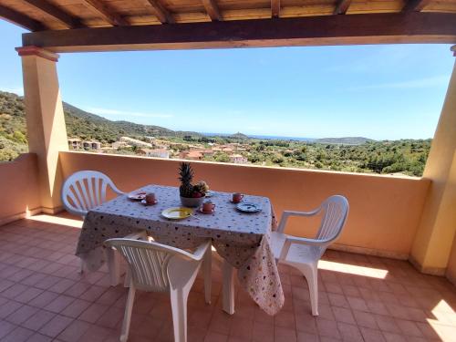 a table and chairs on a balcony with a view at LE DOMUS DE CHIA_Tipo A in Chia