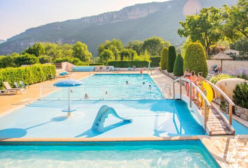 a swimming pool with a slide in a resort at Camping RCN Val de Cantobre in Cantobre