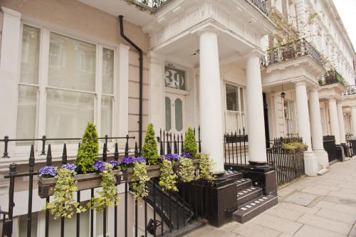 une clôture noire avec des fleurs sur une maison dans l'établissement 39 Studios, à Londres