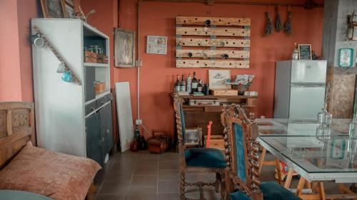 a dining room with a glass table and a refrigerator at B&B La Buonora in Sinio