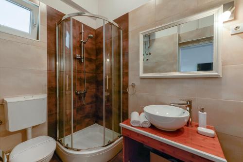 a bathroom with a shower and a toilet and a sink at Sara Residence in Zadar