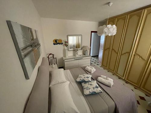 a bedroom with a large bed and a sink at Cielo e Mare Mondello in Palermo