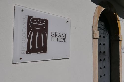 a sign on the side of a building at Ristolocanda Grani Di Pepe in Flaibano