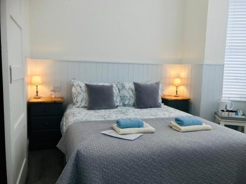 a bedroom with a bed with two pillows on it at Arden House in Arundel