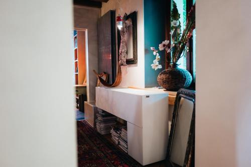 a bathroom with a white sink and a vase at Ristolocanda Grani Di Pepe in Flaibano