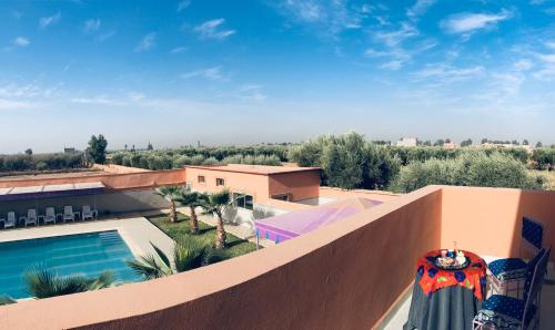 a view from the balcony of a house with a swimming pool at Riad Nasma Souihla in Marrakech
