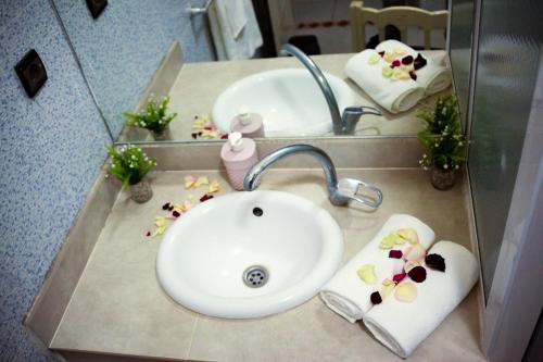 a bathroom counter with a sink and a mirror at Riad Nasma Souihla in Marrakesh