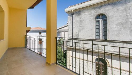 a balcony with a view of a building at Ferienwohnung Laura in Seneghe