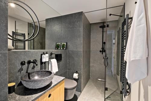 a bathroom with a sink and a glass shower at Harda House Friends & Spa in Zakopane
